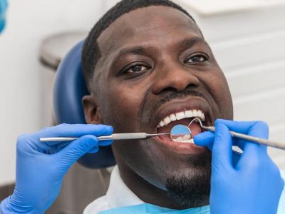 dental-hygienist-examining-african-male-patient-teeth-using-professional-dental-tools_198115-4926_jpg_75